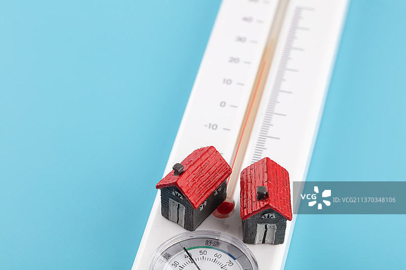 两个小房子模型在温度表上图片素材