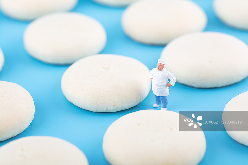 面点师人偶和做好的饼干在蓝背景上图片素材