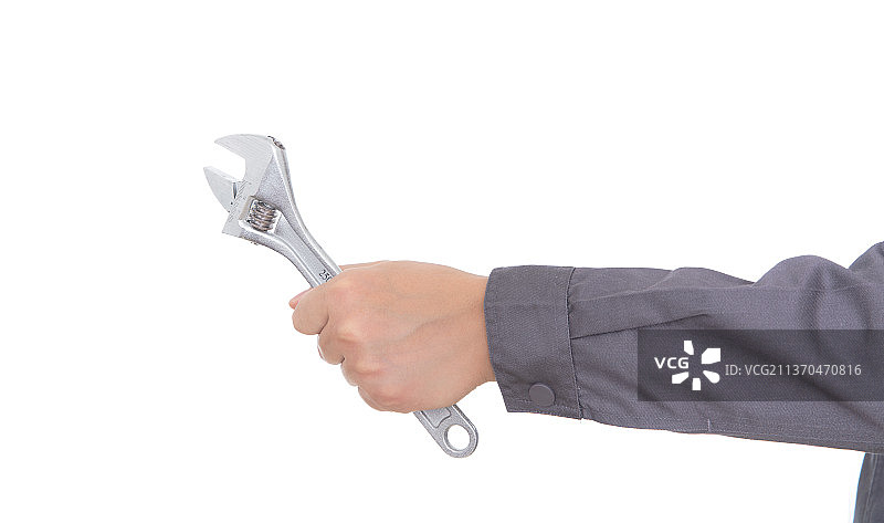 白背景前一只手拿着扳手工具图片素材