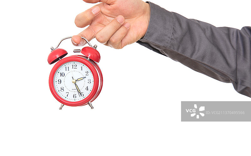 白背景前的手里拿着闹钟特写图片素材