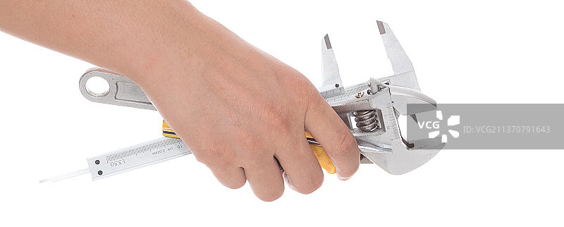 手拿各种各样的工具在白背景前图片素材