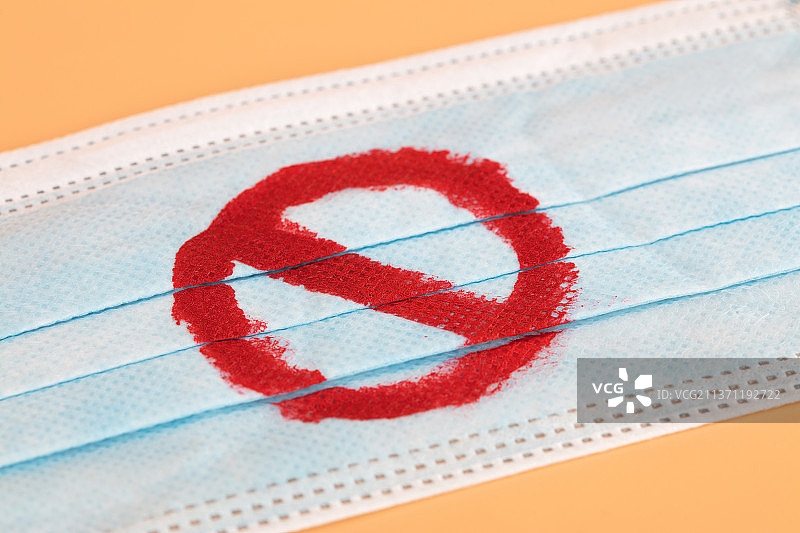 画着禁止符号的蓝色口罩图片素材