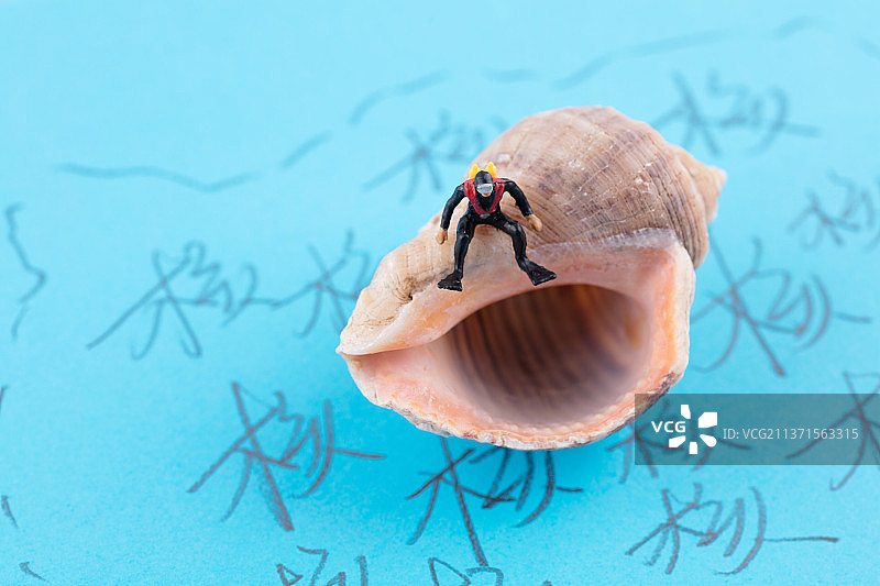 污染海洋区域坐在海螺壳上的潜水员图片素材