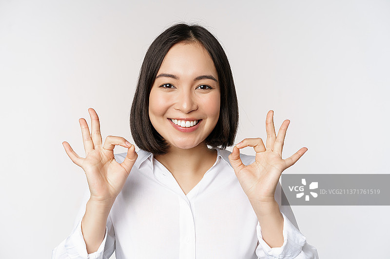 亚洲女孩做出OK手势的头部特写图片素材