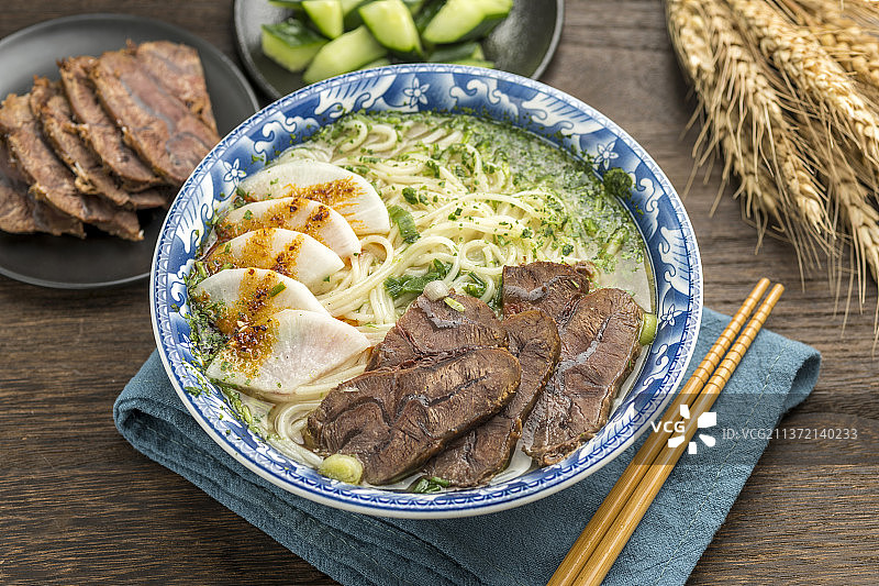 一碗兰州牛肉拉面摆放在木桌面上图片素材