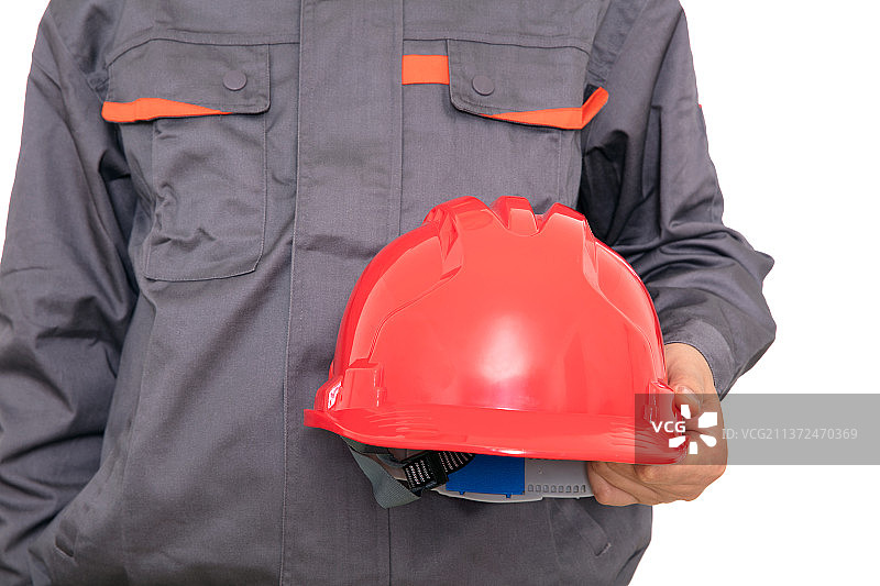 建筑工人手里的红色安全帽图片素材