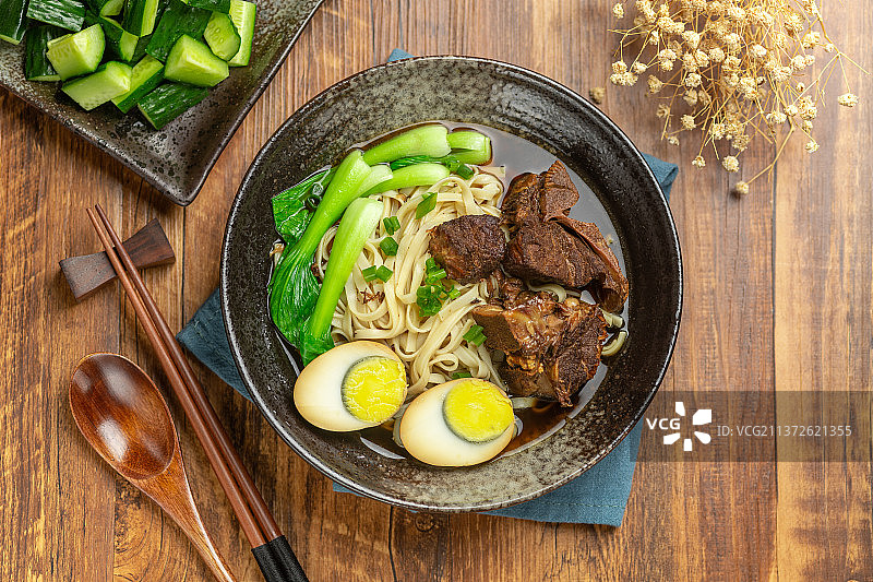 一碗排骨卤蛋面摆放在木桌面上图片素材