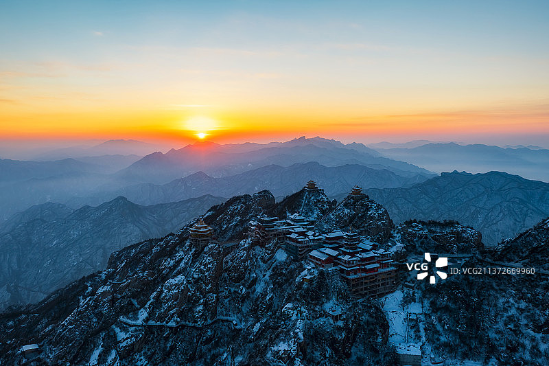 河南洛阳栾川老君山金顶道观群金殿冬季雪景日出逆光航拍视角图片素材