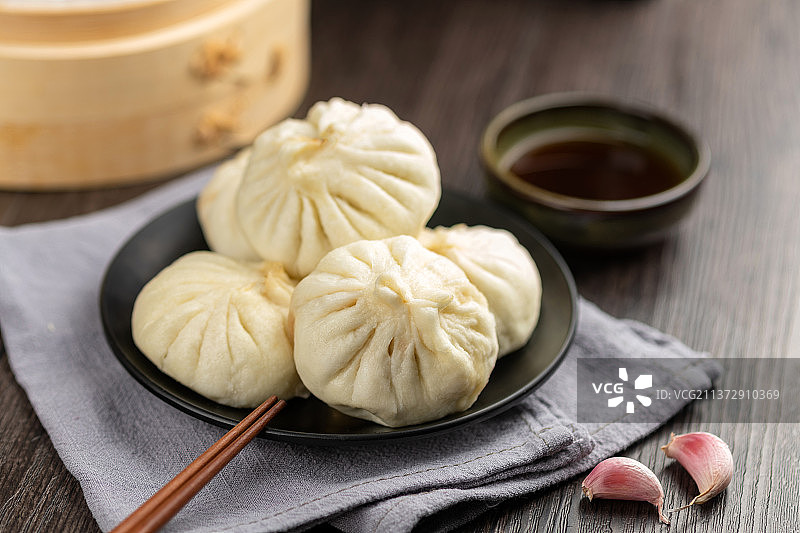 一盘包子特写木纹桌面背景图片素材