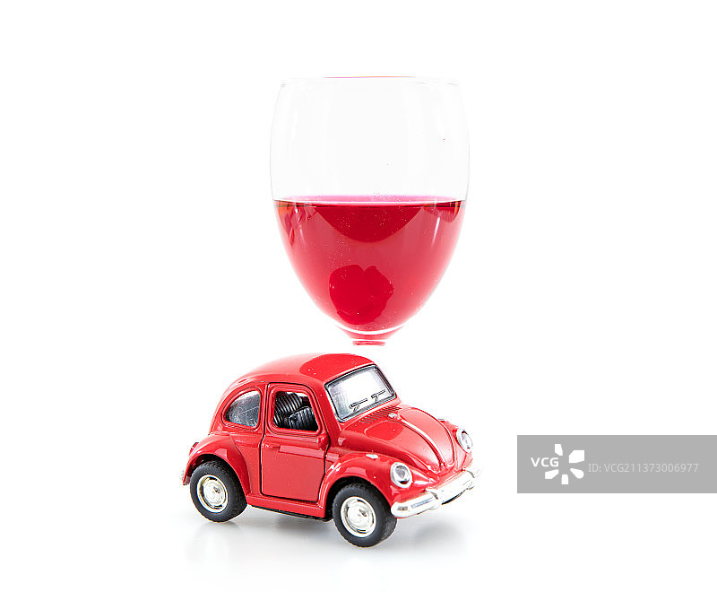 白背景上一杯红酒和一辆小汽车模型图片素材