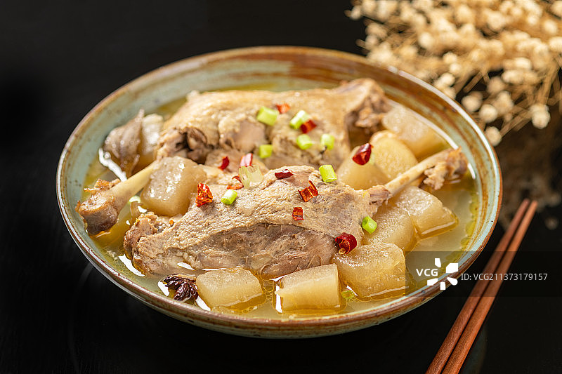 酸萝卜鸭腿汤特写黑色背景图片素材