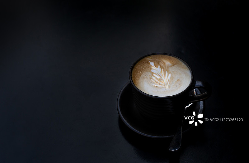 黑色桌面上的咖啡杯与勺子，泰国图片素材