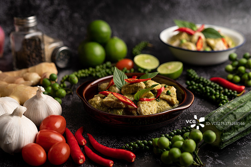 棕色碗装猪肉绿咖喱配黑色水泥香料图片素材