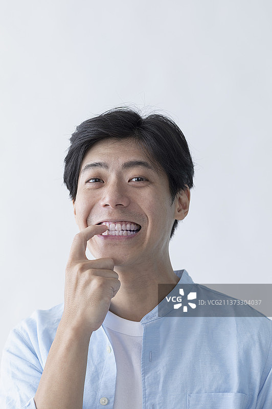 中年男性用手指着自己的牙齿图片素材