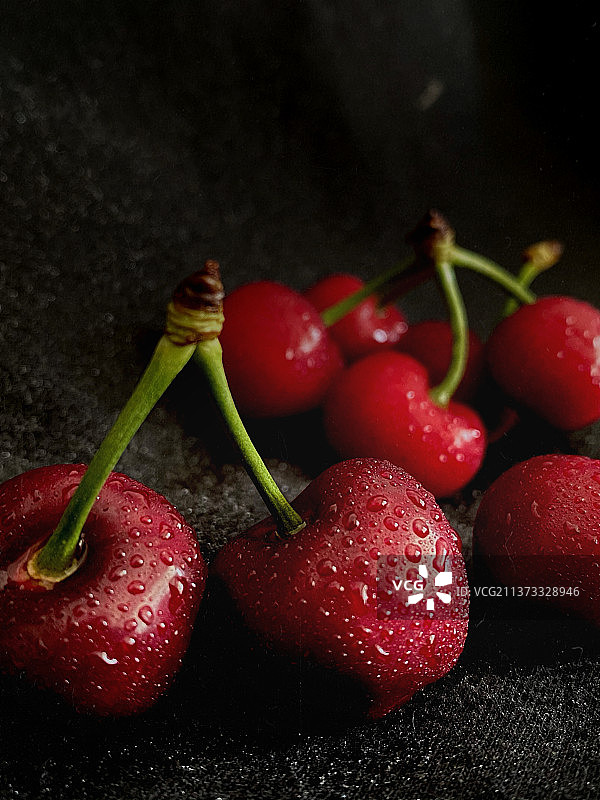 黑色背景下湿樱桃的特写镜头图片素材