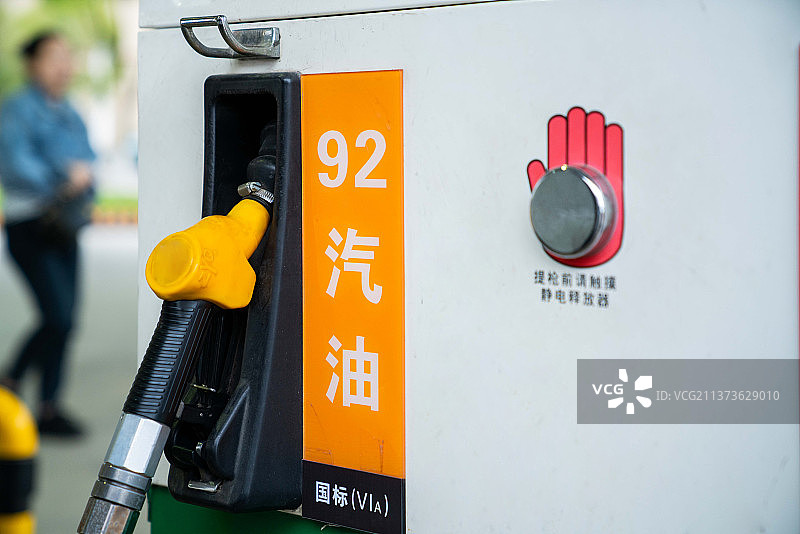 手动加油的汽车与燃料，特写，泵设备的汽油在加油站。图片素材