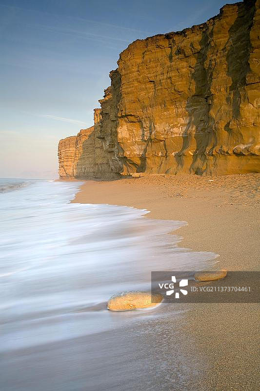 沙滩和海蚀崖景色，侏罗纪悬崖由不同物质层构成，以不同的速度侵蚀，位于英国多塞特郡伯顿布拉德斯托克图片素材