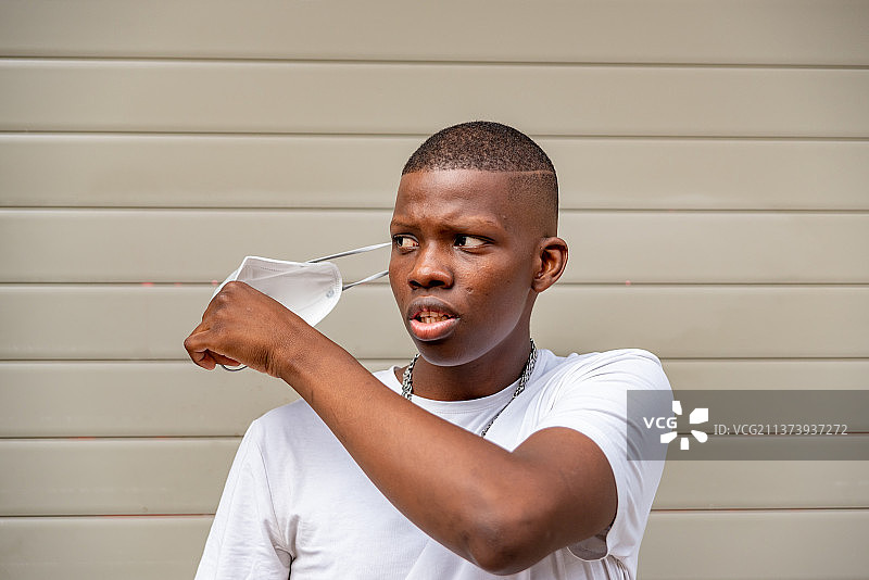 摘下新冠口罩的年轻黑人男子图片素材