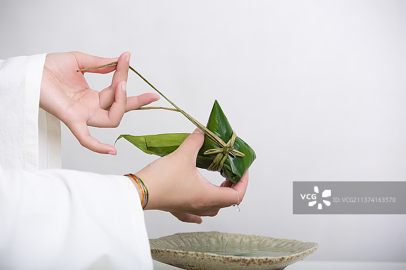 端午节中国风禅意静物：穿汉服女子包粽子图片素材