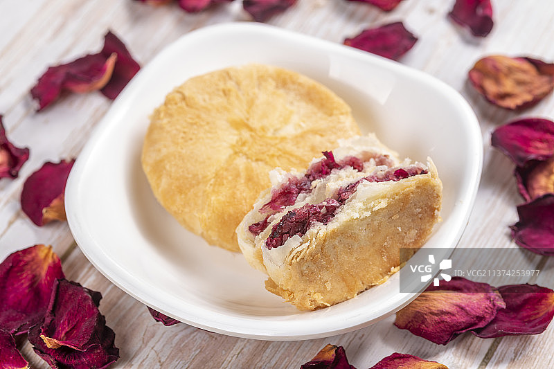 一盘鲜花饼与玫瑰茶玫瑰花瓣特写木桌面背景图片素材