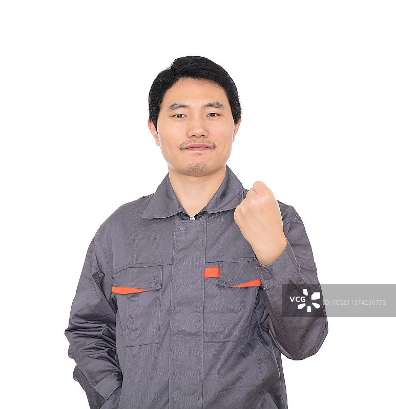 白背景前握拳抬手给自己鼓气的年轻工人图片素材