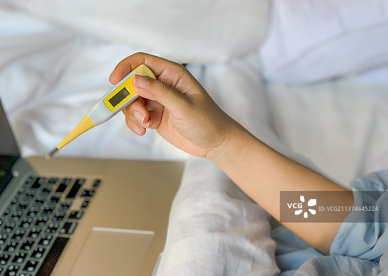 年轻女人感冒发高烧，测量体温图片素材