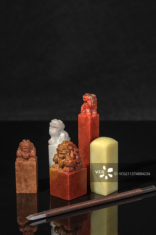 各种款式的印章石章摆放在黑色背景上图片素材