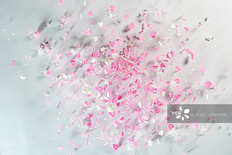 粉色系各类糖果掉落在白色背景上棚拍创意图图片素材