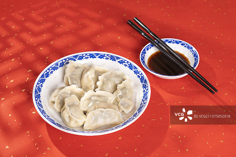 一盘水饺醋碟中国结摆放在桌面上特写图片素材