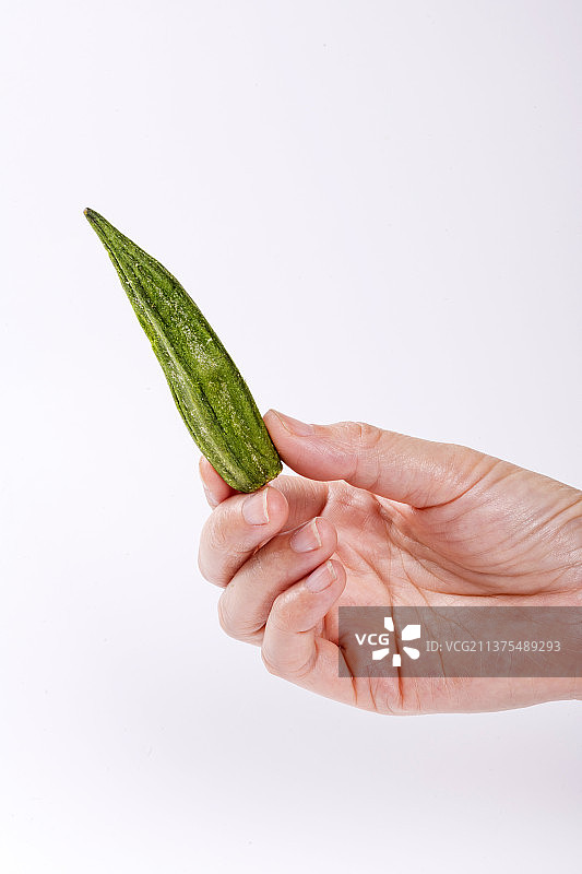 一盘秋葵干果蔬干与茶水摆放在桌面上图片素材