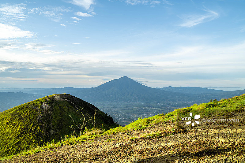 印度尼西亚山脉与广阔的绿色草地图片素材