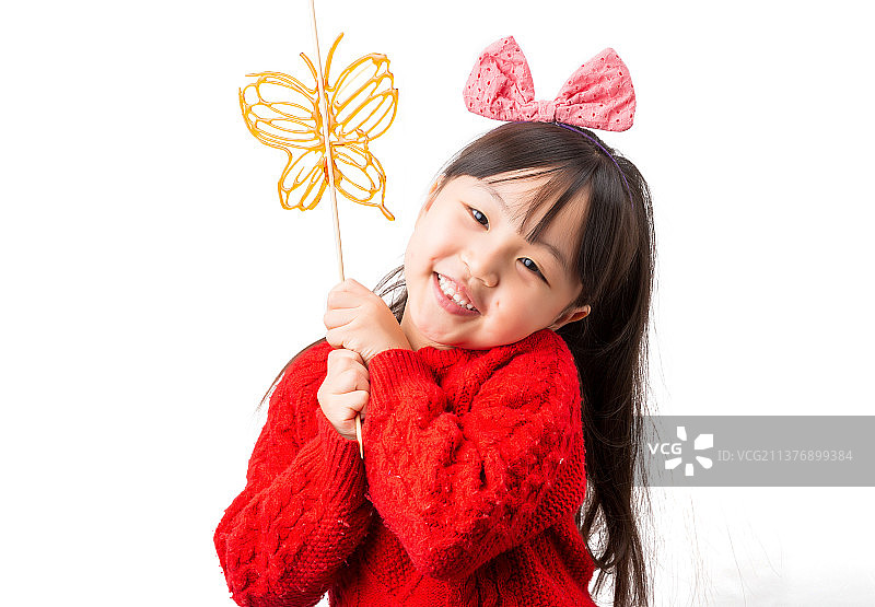 白色背景前吃糖人的小女孩图片素材