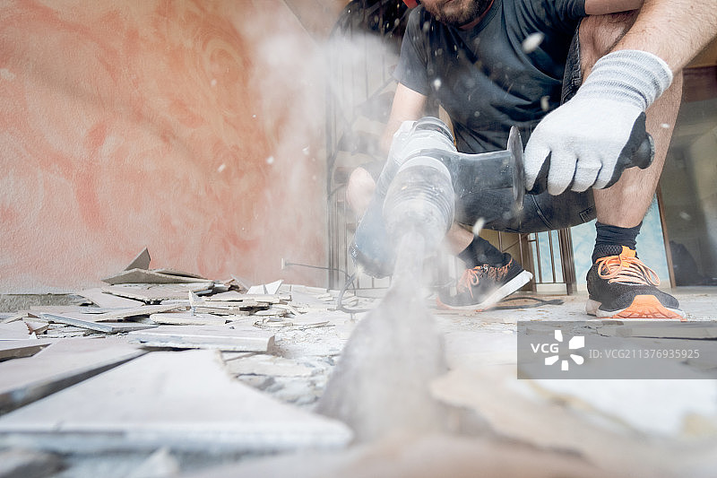 房屋改造工程：工人移除地砖图片素材