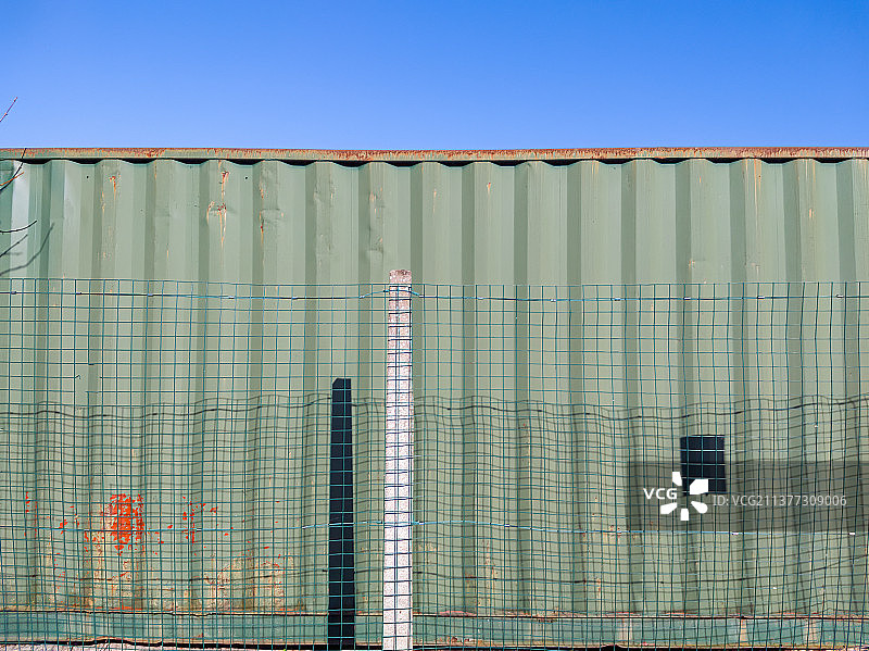 铁丝网后的货运集装箱图片素材