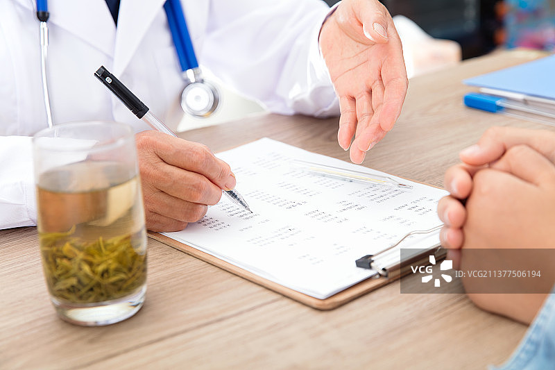 医生指出患者体检报告中有问题的指标图片素材