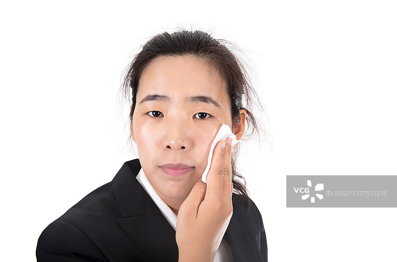 白背景前的漂亮女性正在用卸妆棉卸妆图片素材