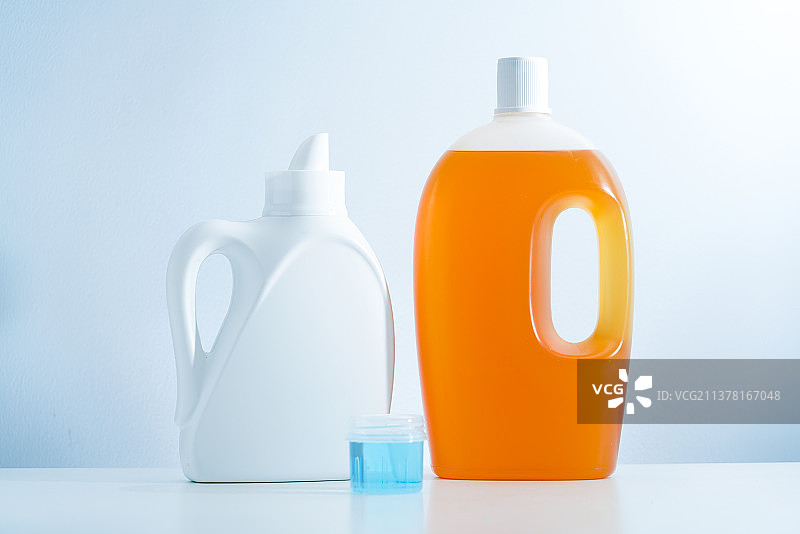 一瓶洗衣液和消毒液放在白色桌面上图片素材