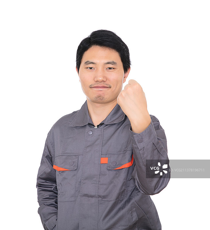 白背景前握拳抬手给自己鼓气的年轻工人图片素材