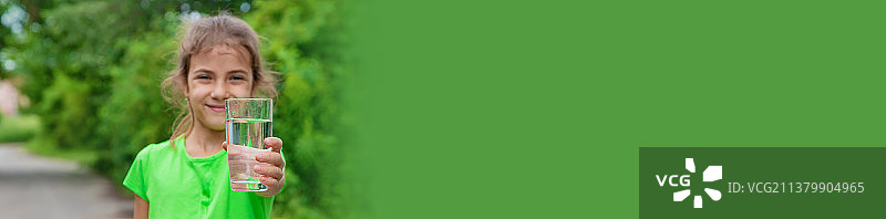 女孩喝玻璃杯里的水（选择性聚焦）图片素材