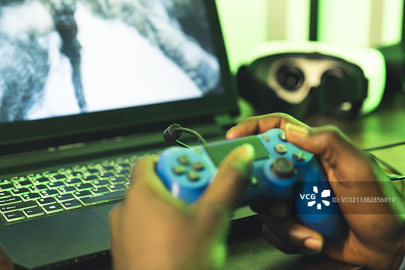 手持蓝色游戏手柄特写图片素材