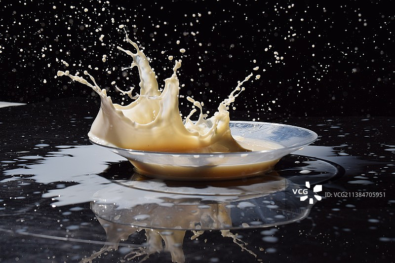 黑色背景牛奶中牛奶飞溅特写图片素材