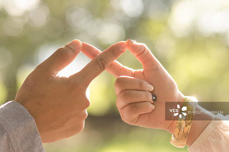 日落时分情侣手指相触的剪裁图像图片素材