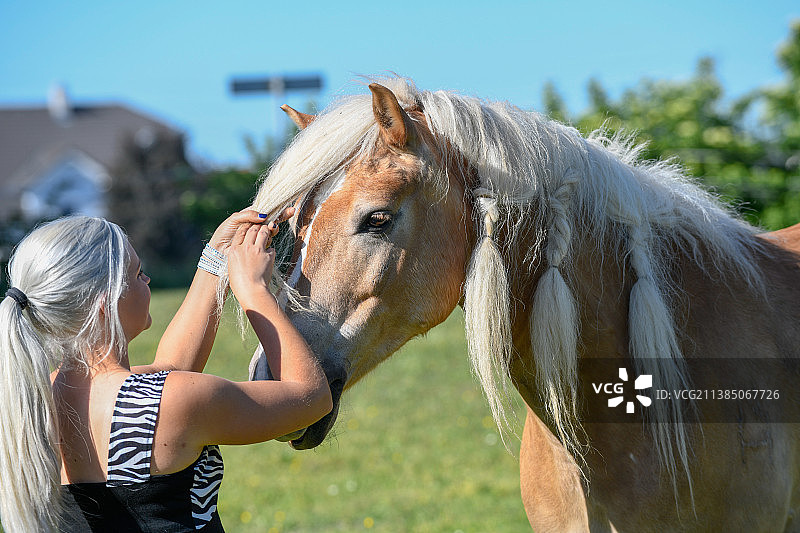 女人和纯种小马在田野上图片素材