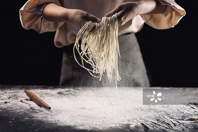 高雅女人制作面条，手抖动面条特写图片素材