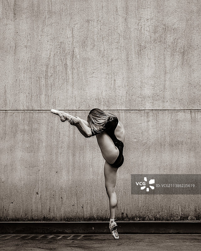 靠墙跳舞的妇女侧面像图片素材