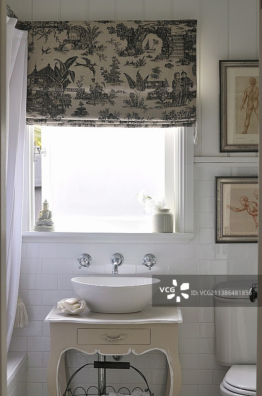 古董风格柜子上的洗脸盆，窗户下是印有中国图案的罗马帘图片素材