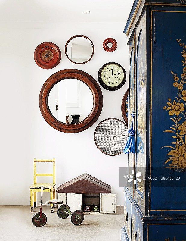 复古风格儿童卧室：三轮车、小椅子、圆形镜子与彩绘衣柜图片素材