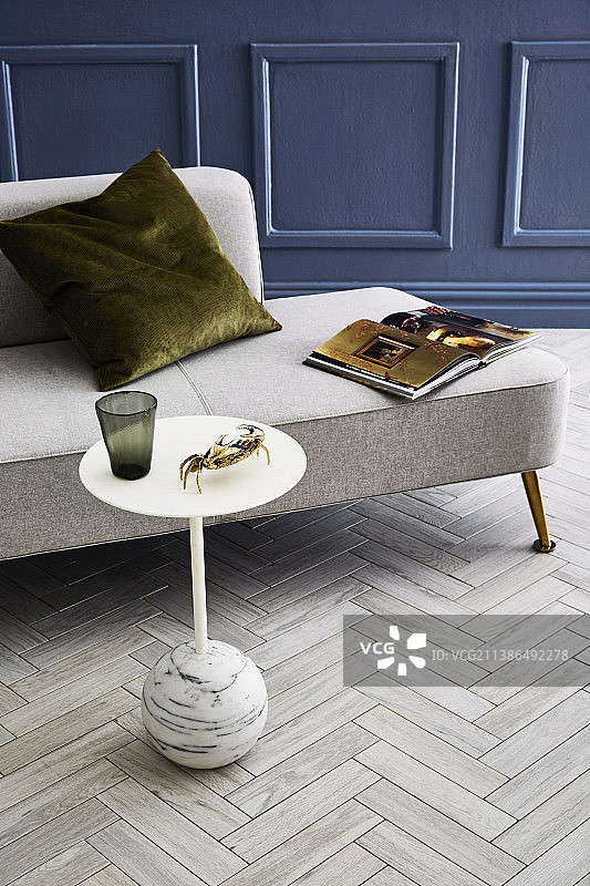 躺椅前的边桌，摆放着螃蟹摆件和玻璃杯图片素材