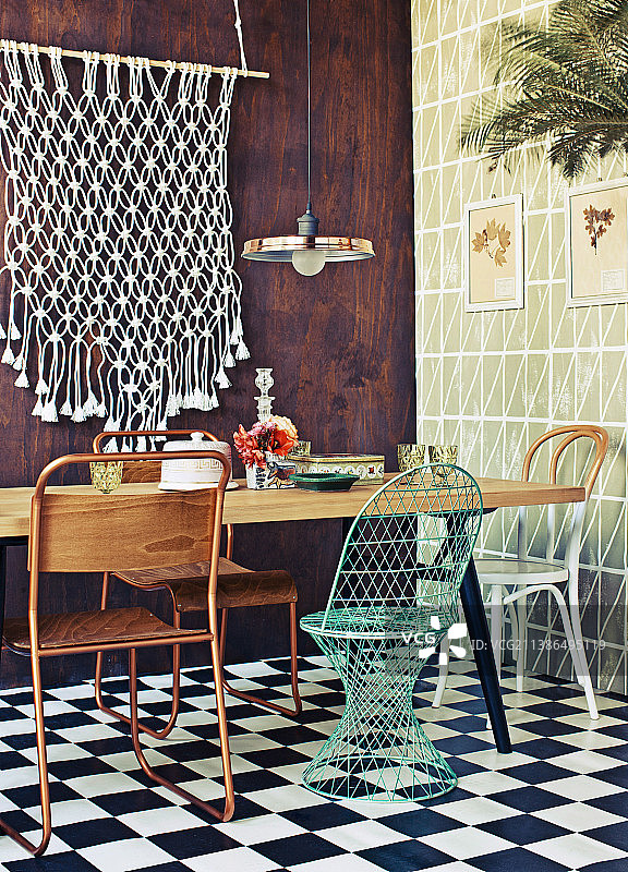 餐桌与各种椅子，墙壁上挂着macrame图片素材
