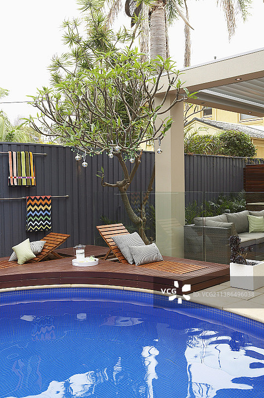 花园泳池露台周围的日光浴床图片素材